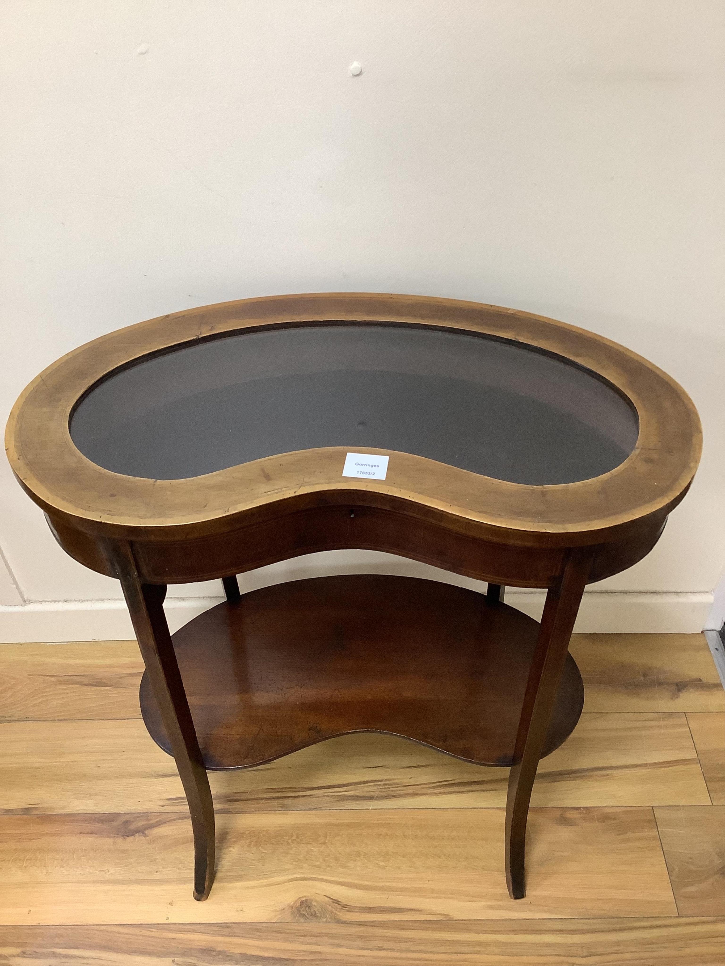 An Edwardian mahogany kidney shaped bijouterie table, width 68cm, depth 39cm, height 73cm. Condition - fair
